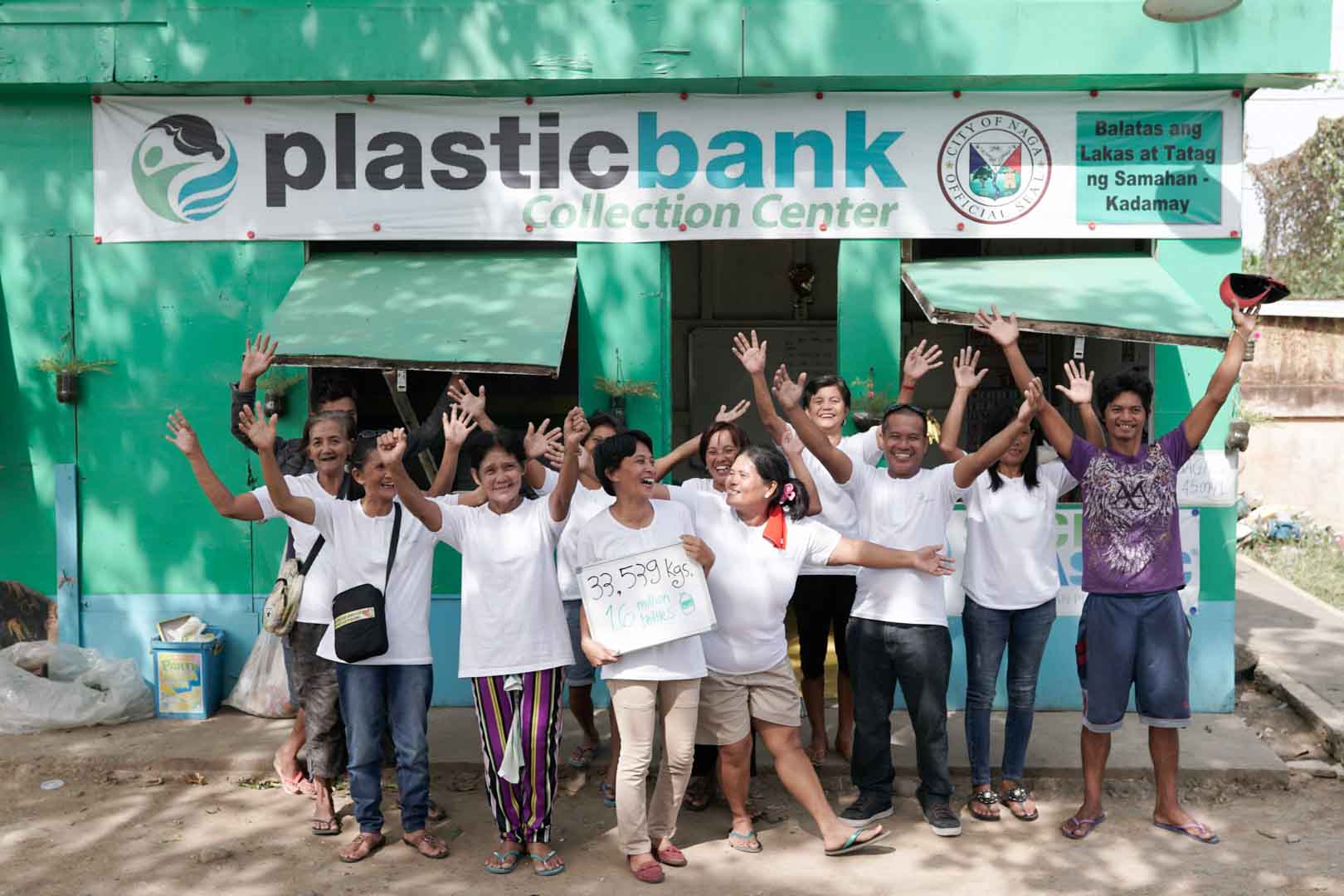 People standing in front of Plastic Bank