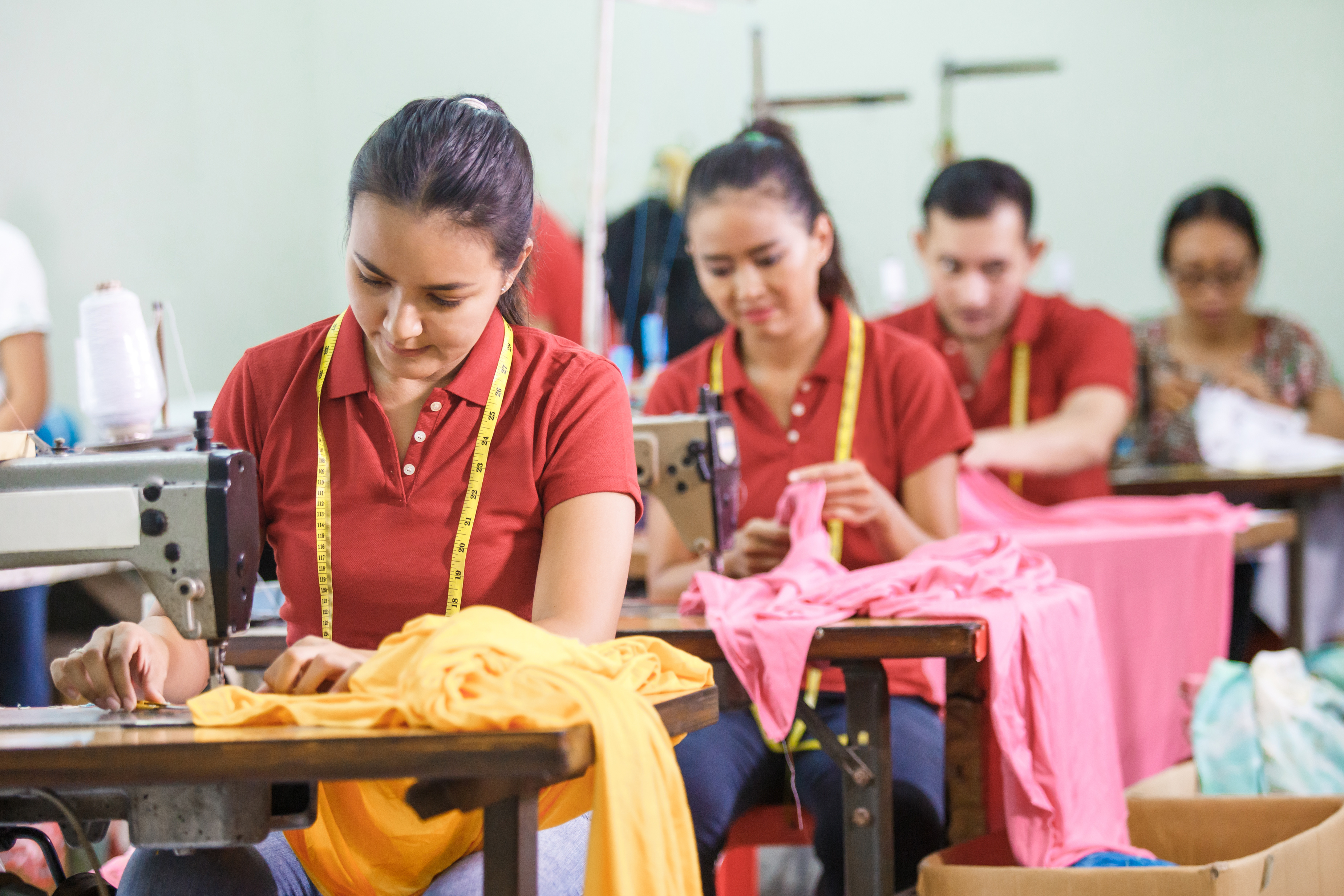 Asian garment workers working in factory line
