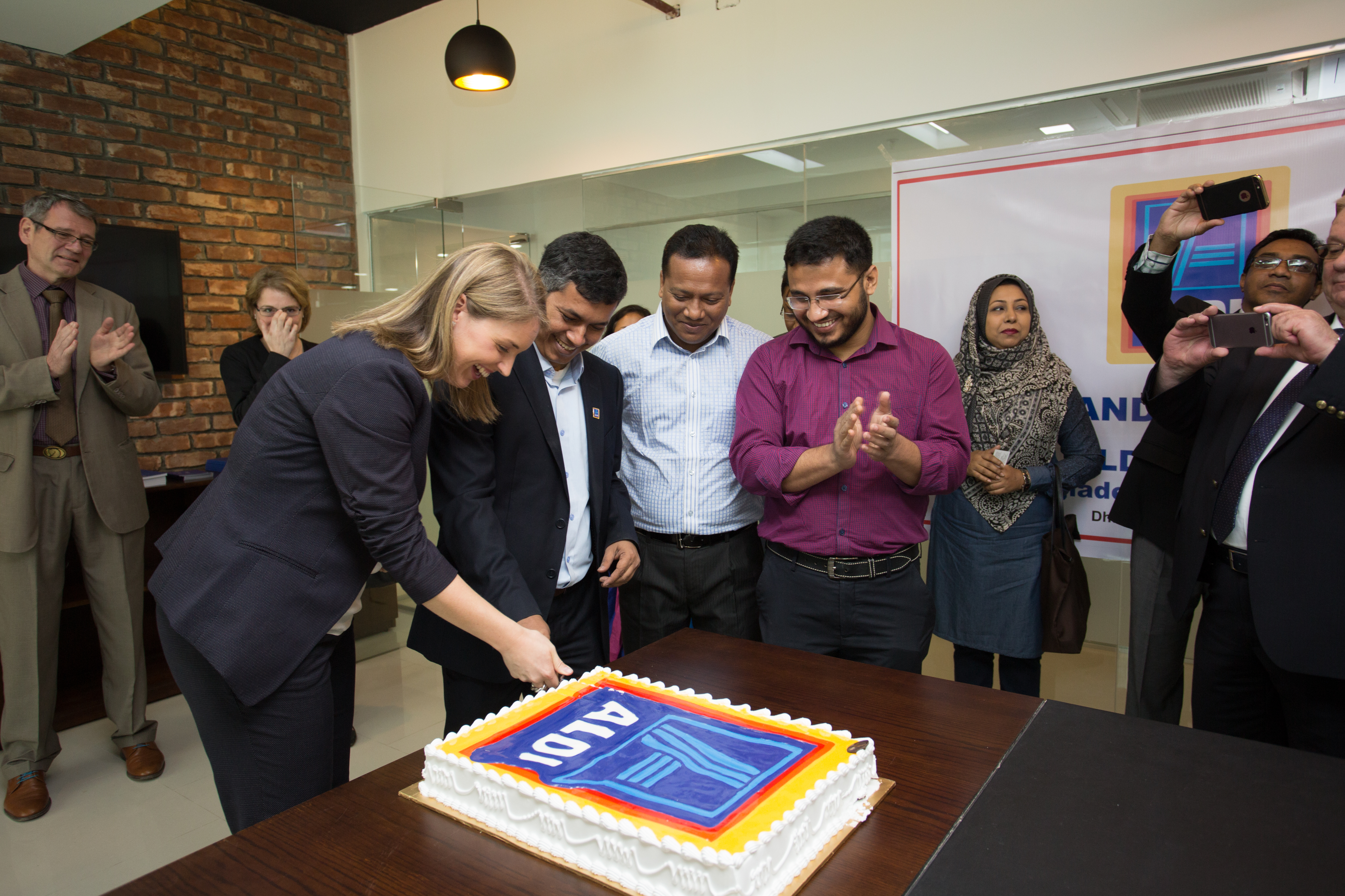 Anke Ehlers cutting cake on the opening of the Bangladesh CR office