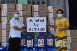 Two women holding ALDI donation sign