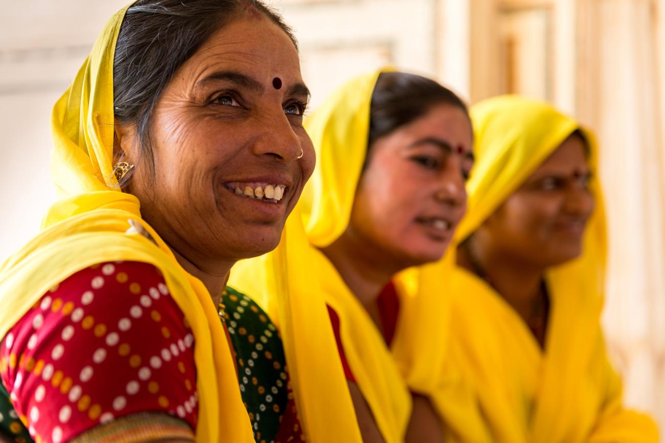 Three Indian women with yellow head scarfs