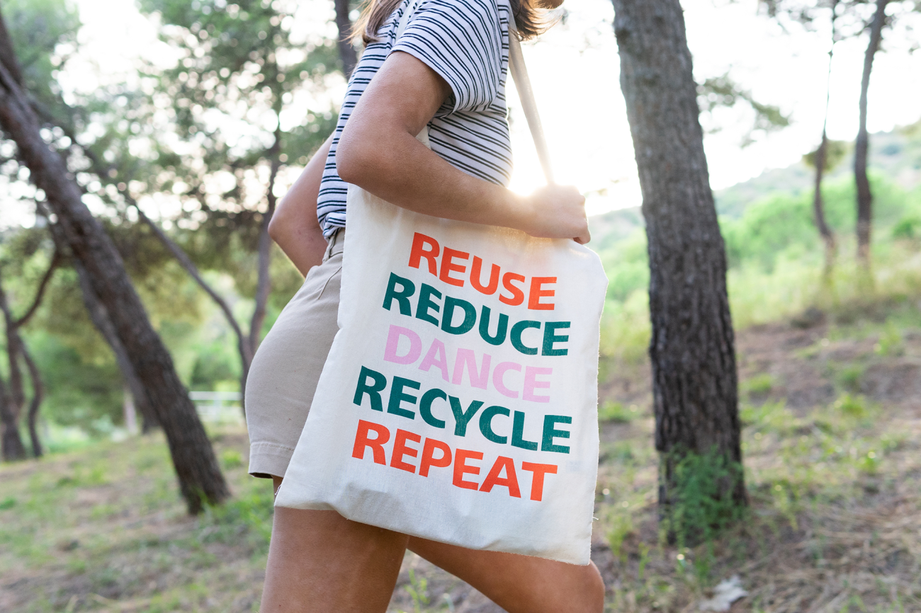 Woman walking with shopping bag reuse reduce recycle